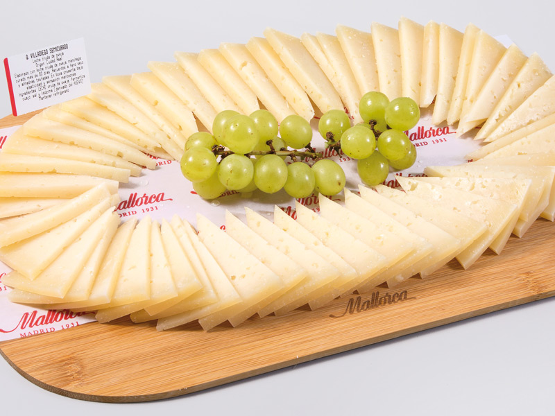 Queso manchego semicurado con leche cruda. Acompañado de uvas y picos camperos Queso manchego semicurado con leche cruda. Acompañado de uvas y picos camperos